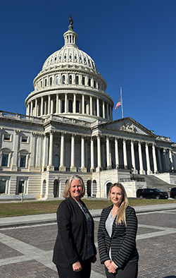 Brittany Tweed and Carrie Short pose with the Capitol Building in the background