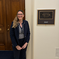 Danielle Hayden standing outside Rep. Angie Craig's office