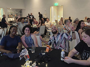 Florida Annual Training Conference attendees smile sitting around a table