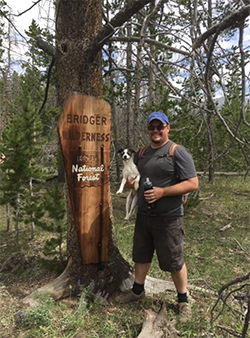 Joe hiking with a dog